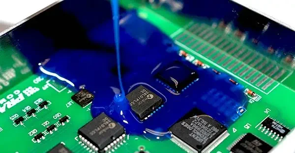 Protective material dispensed around electronic components