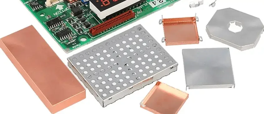 Shield covers and metal pieces beside circuit board