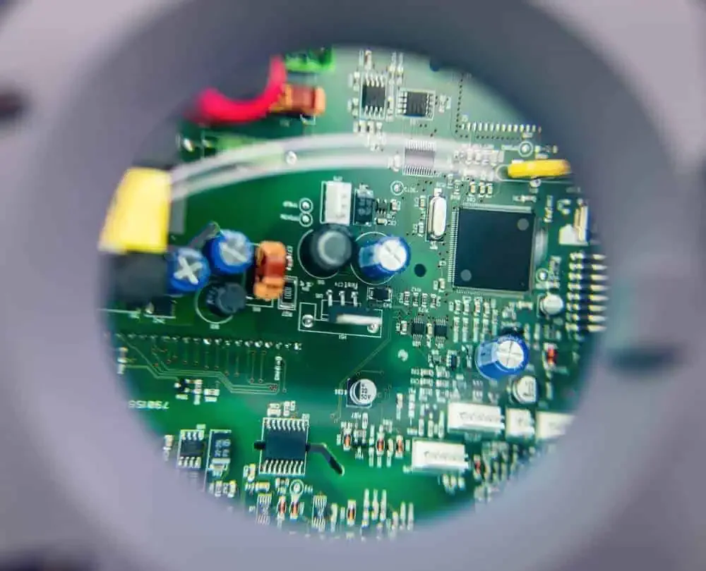 Populated circuit board viewed through an inspection lens