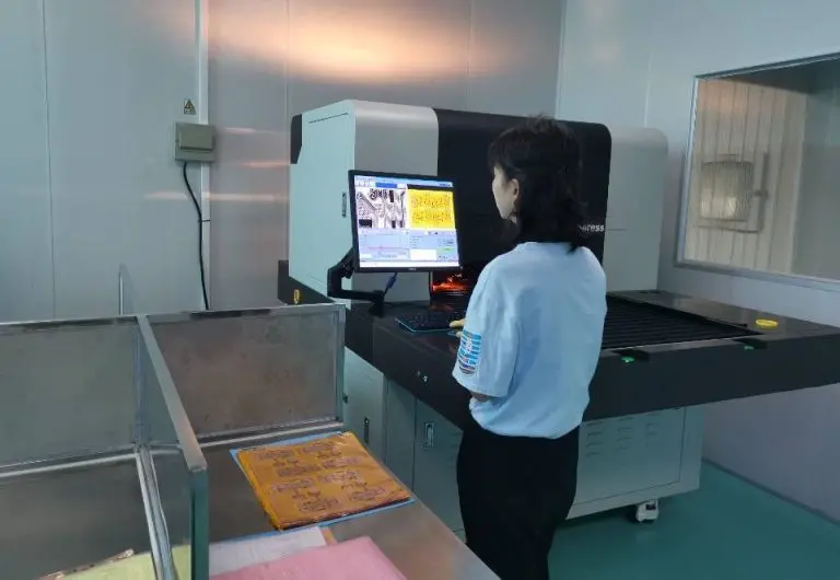 Operator inspecting flexible circuit panels using imaging equipment